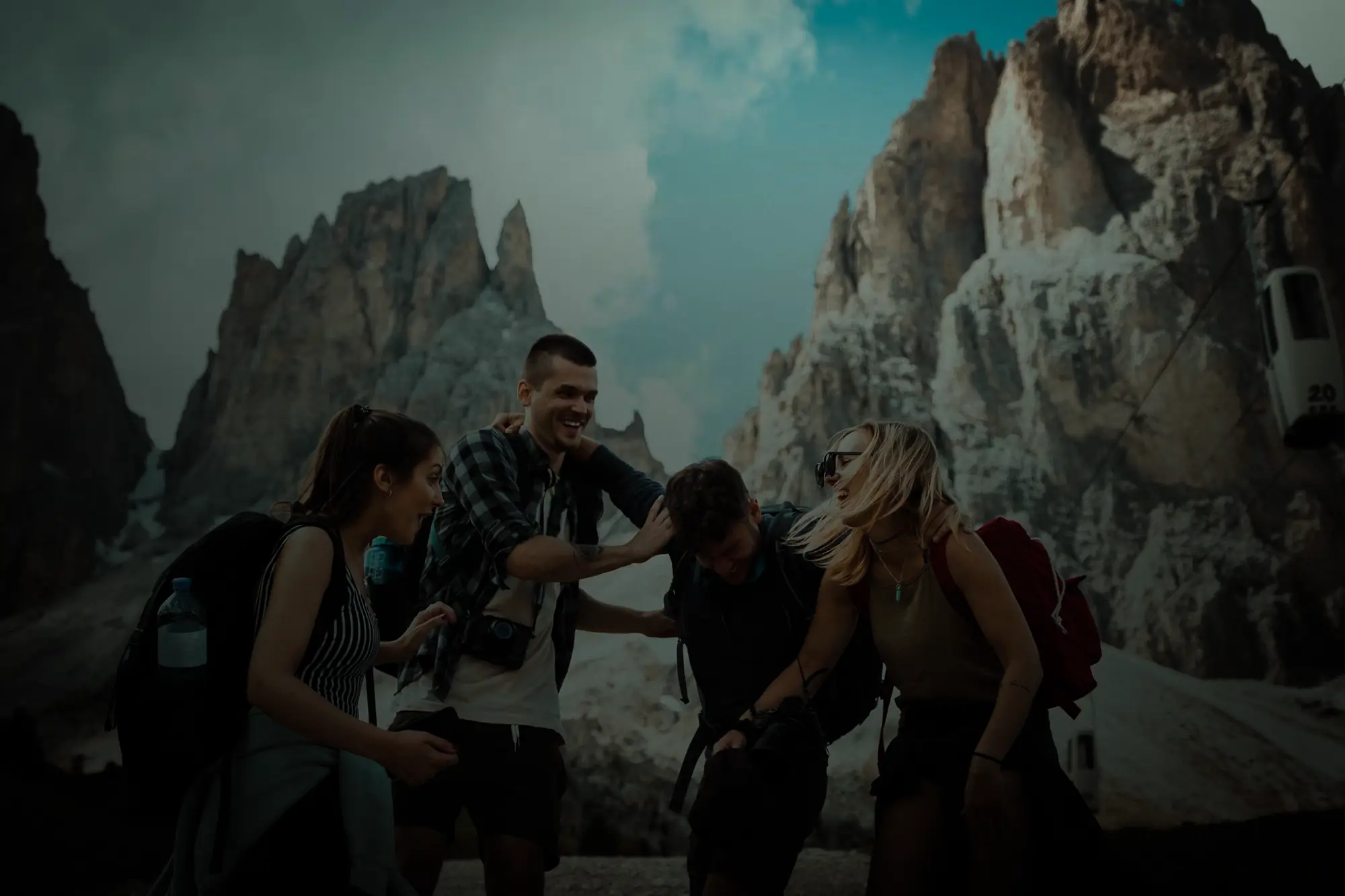 Friends laughing together on a mountain trip